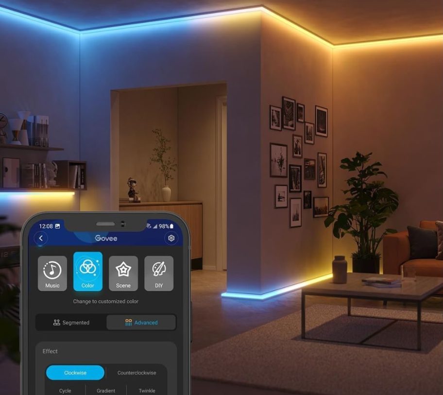 A room with Govee Strip lights and the Givee app on a phone to adjust them