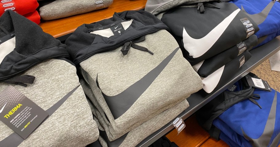 Nike hoodies on a store display table