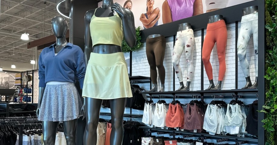 store display of CALIA athletic clothing with mannequins and back wall with leggings and sports bras