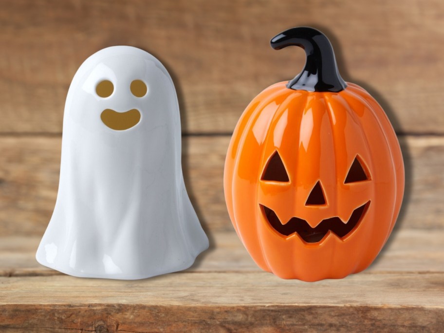 a white ceramic light up ghost and an orange and black ceramic jack-o-lantern