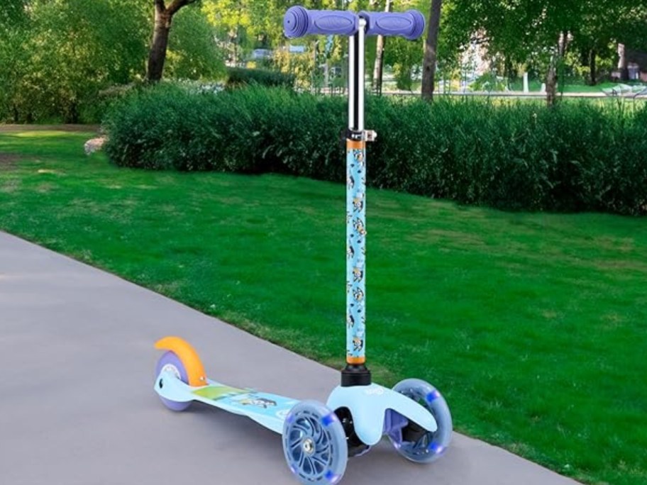 kid's Bluey 3 wheel scooter standing on a sidewalk outside