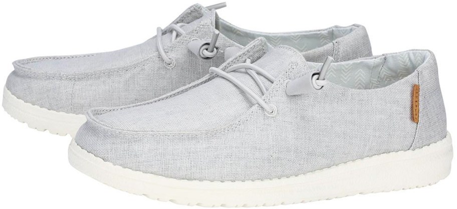 pair of light grey slip-on heydude sneakers
