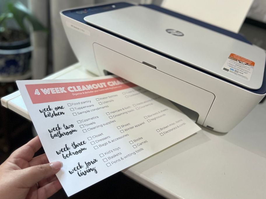 printer with the 4-week home declutter challenge checklist on it