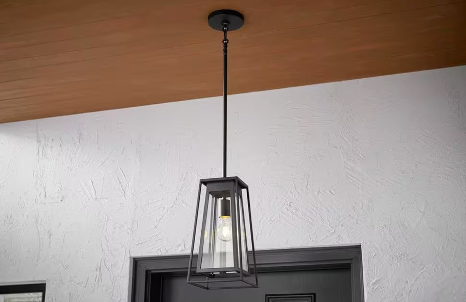 black pendant light hanging from patio ceiling