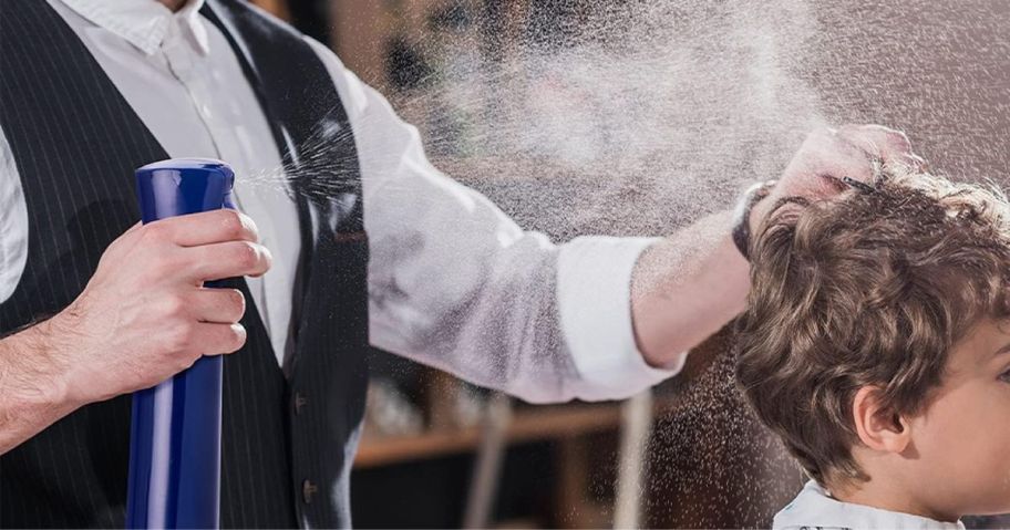 man using Hula Home Continuous Spray Bottle to spray boy's hair