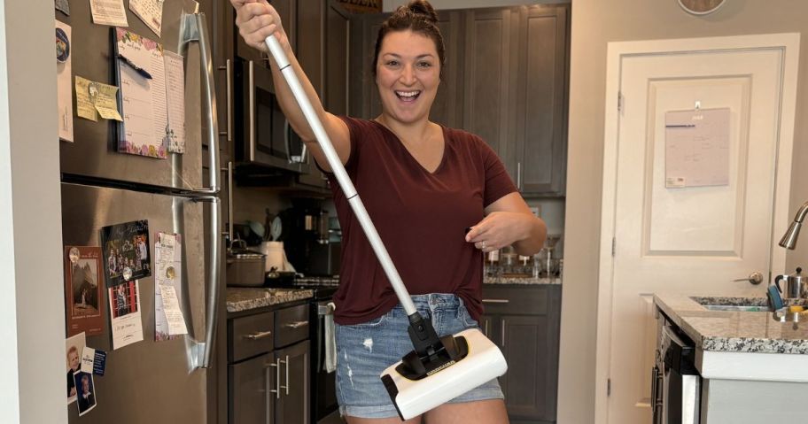 Woman holding up a Karcher Crodless Broom