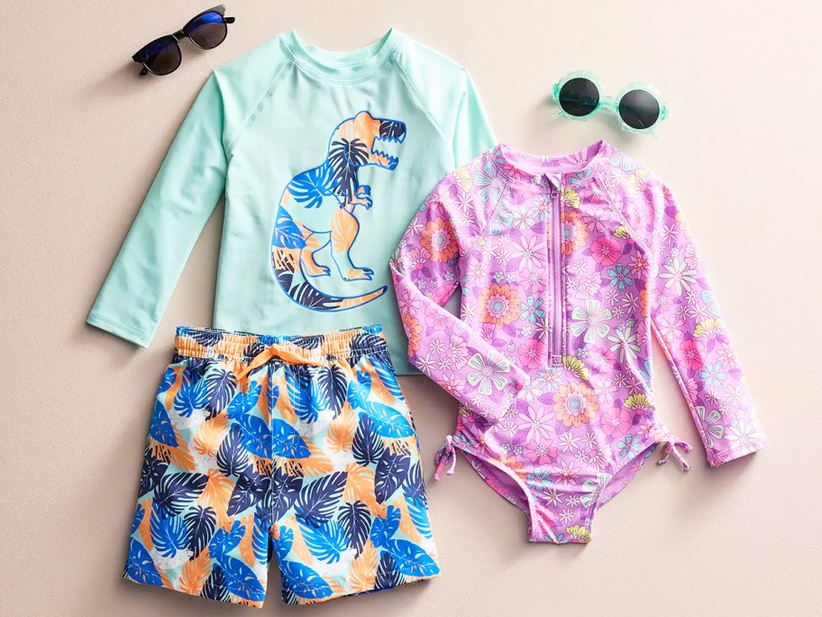 rash guard, swim trunks, and one-piece bathing suit with sunglasses