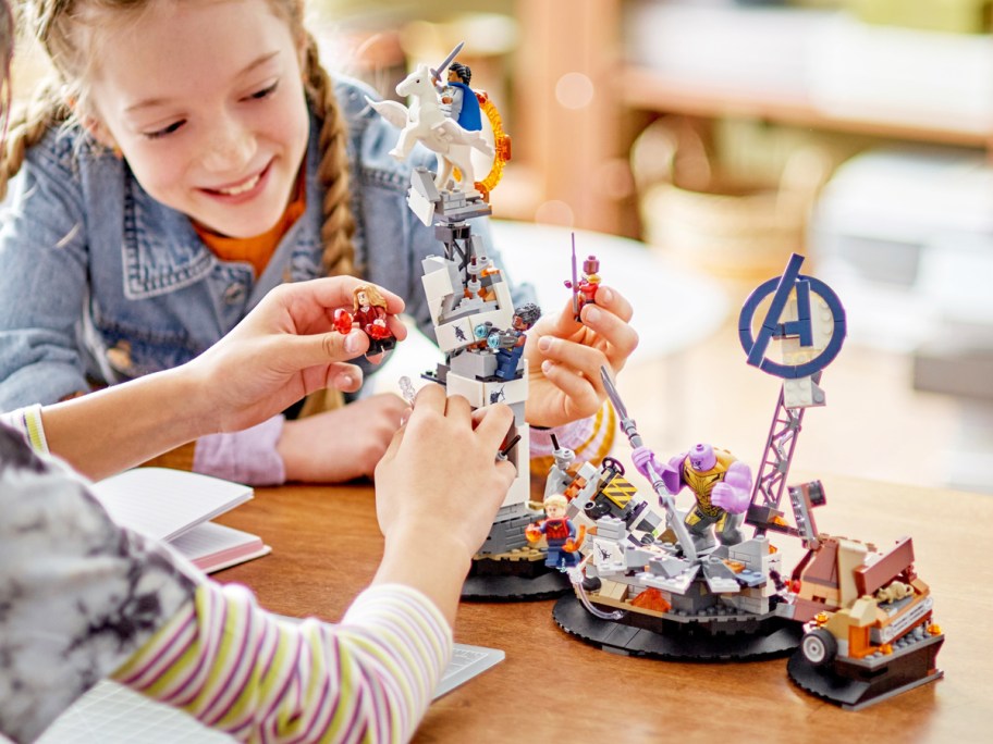 two girls playing with LEGO Marvel Endgame Final Battle set