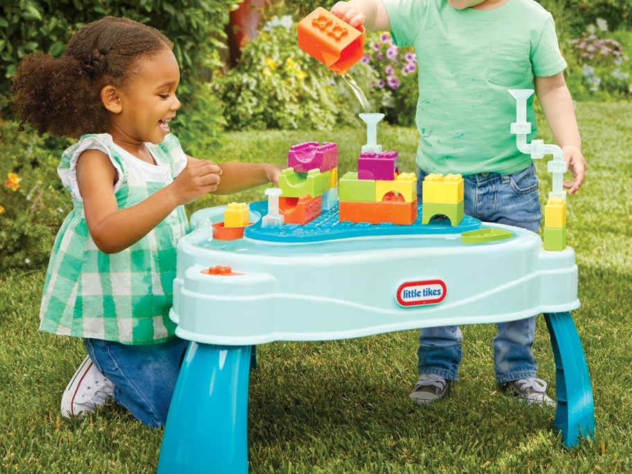 two kids playing at Little Tikes Build & Splash Water Table outside