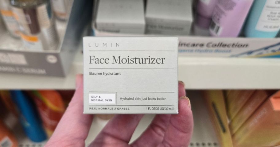 Lumin Face Moisturizer 1oz being held by hand in store