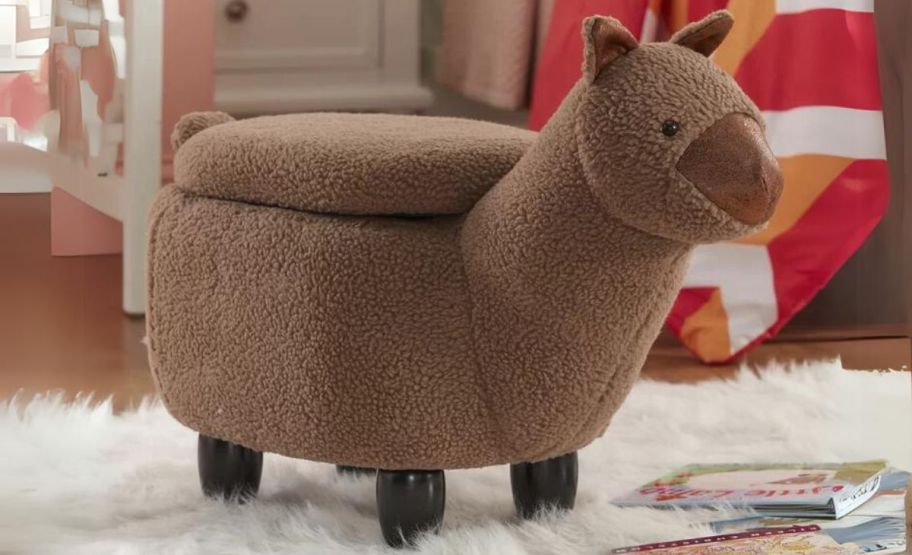 a llama shaped storage ottoman on a rug in a playroom