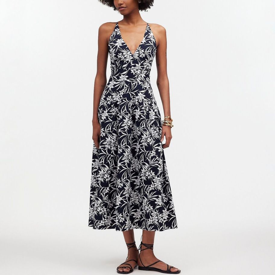 a woman wearing a navy & white floral print maxidress