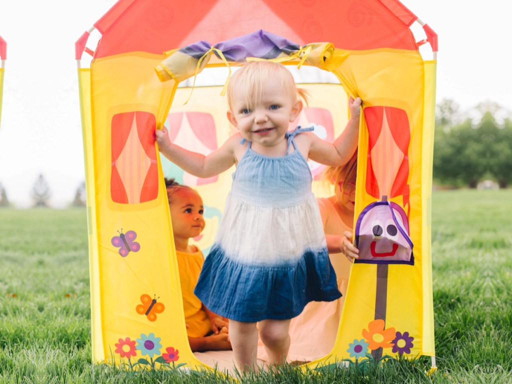 little girl onlineing out door of blues clues play tent