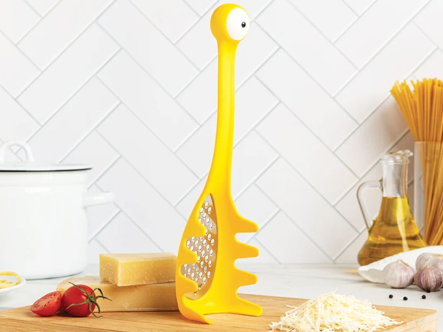 yellow one-eyed monster pasta spoon with built in cheese grater