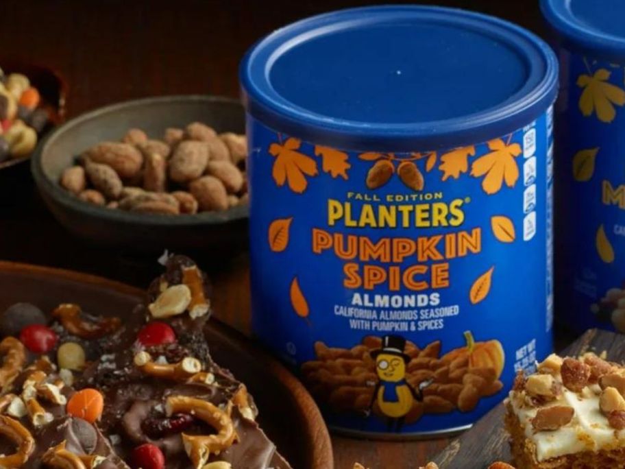 A Planters Fall Edition Pumpkin Spice Almond canister surrounded by fall treats