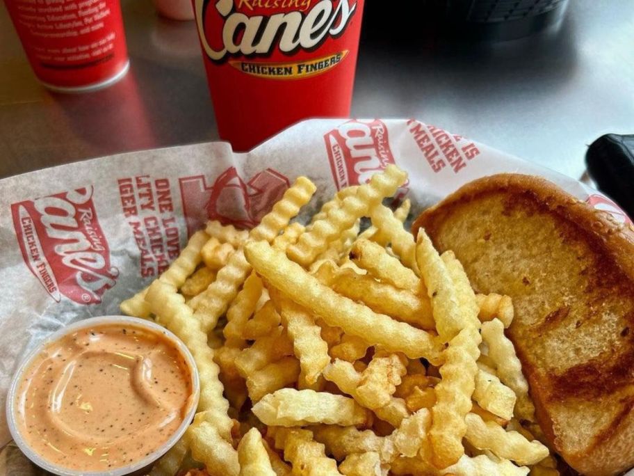 Raising Caen's Krinkle Cut Fries in a basket with sauce and toast.