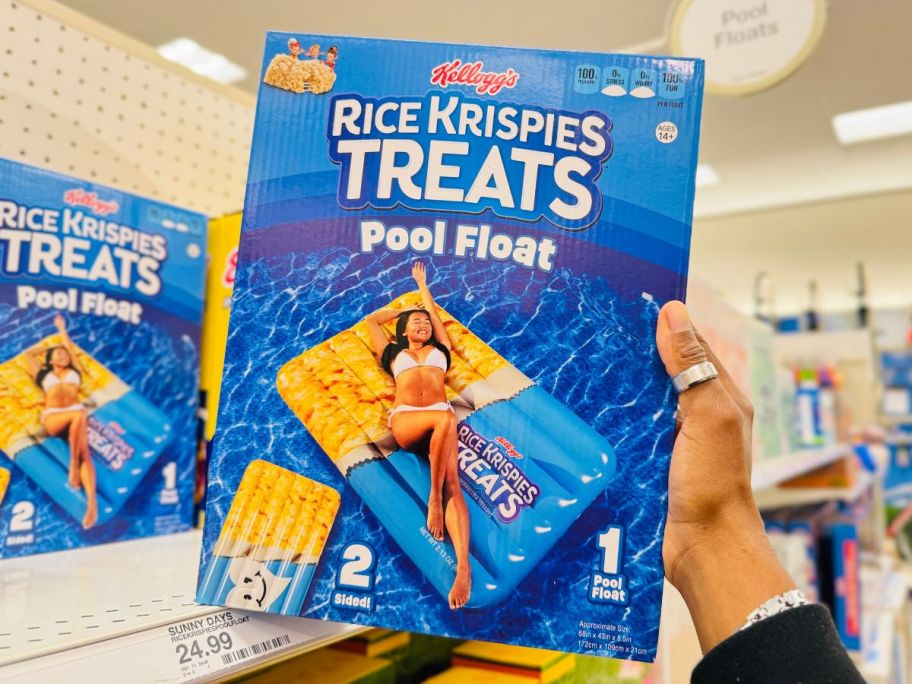 A person holding a Rice Krispies Pool Float in a box