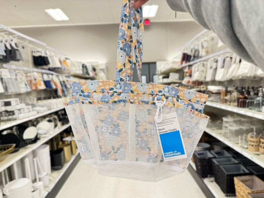 Room Essentials Mesh Shower Caddy being held by hand in store