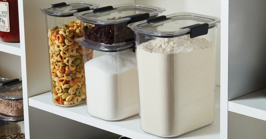 a set of clear food storage containers on a shelf in a pantry