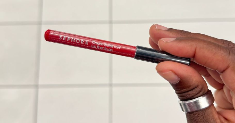 A woman holding a Sephora Lip Liner To Go