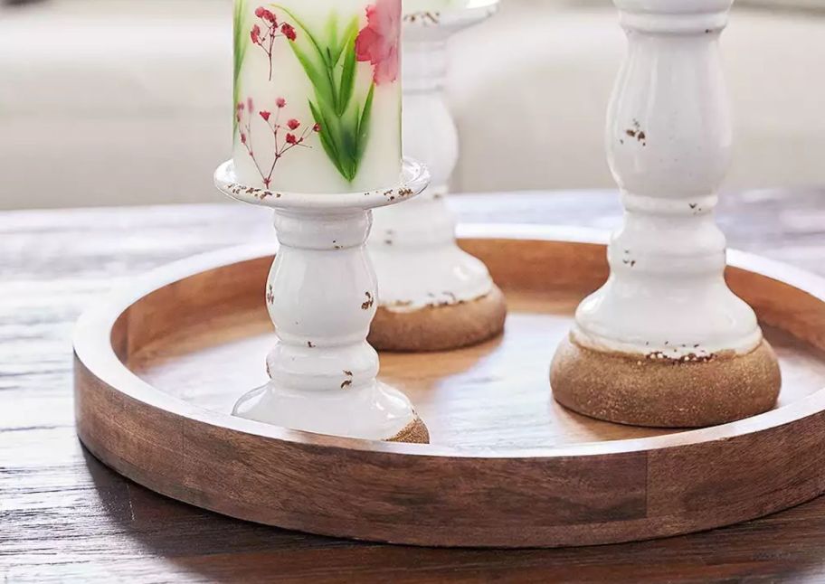 a mango wood tray on a table with candles