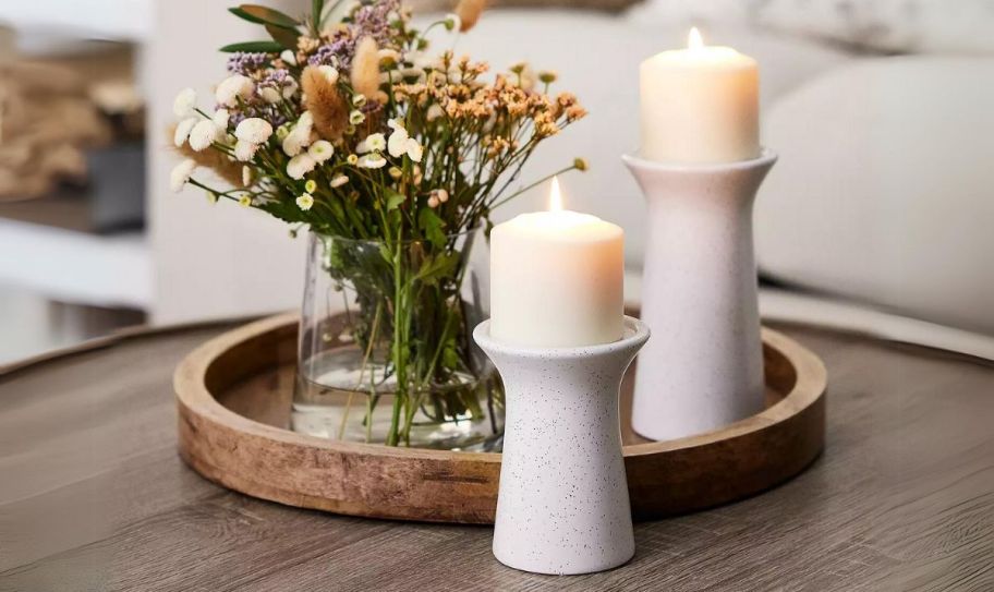 a mango wood tray on a table with a bud vase and two candles