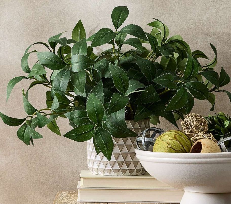 an faux houseplant on a console