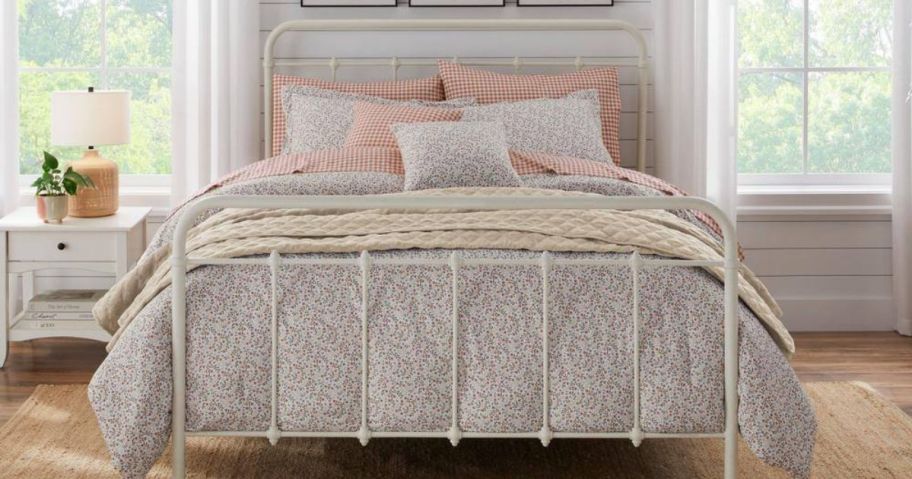 A bed with a floral onlineforter