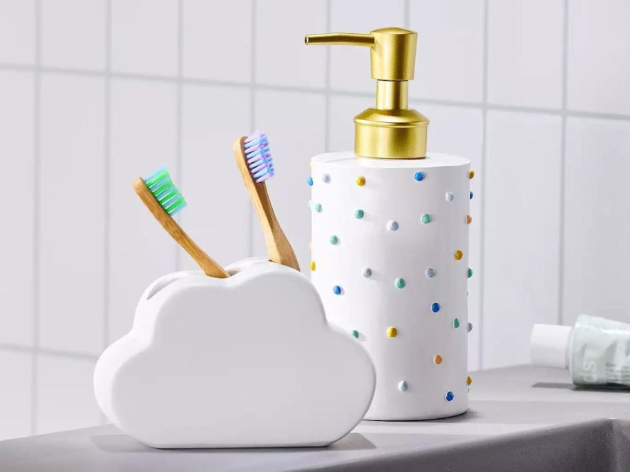 The Big One Kohl's Bathroom Accessories witha cloud shaped toothbrush holder and white soap dispenser with colored dots on it