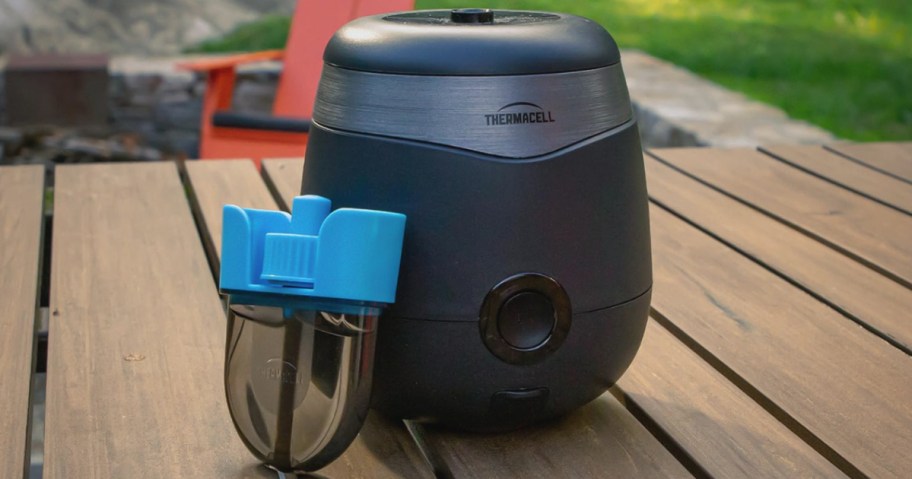 Thermacell Mosquito Repeller on picnic table next to refill cartridge