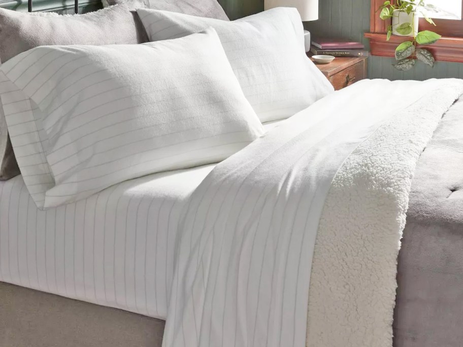 white striped sheet set on bed