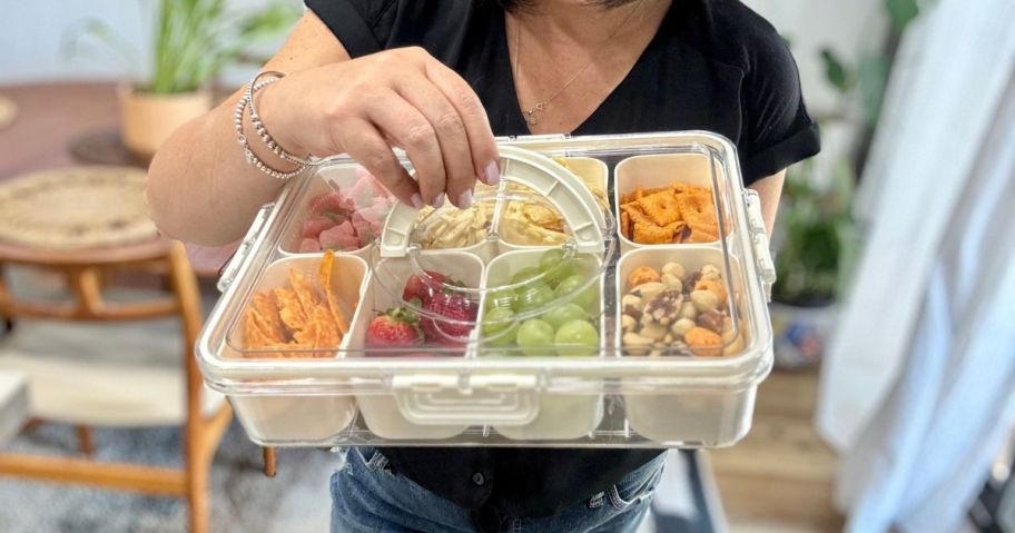 A woman holding a Divided Serving Tray with lid and Handle