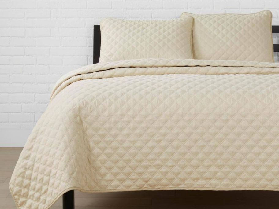 A bed with a cream colored onlineforter