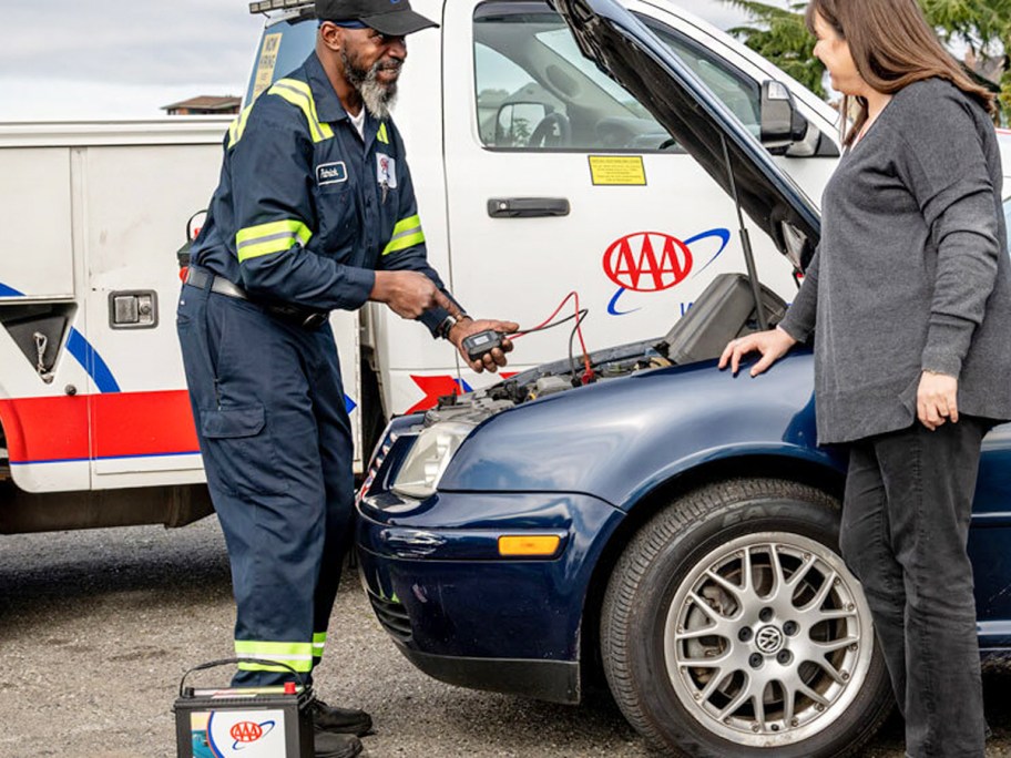 man checking battery in car