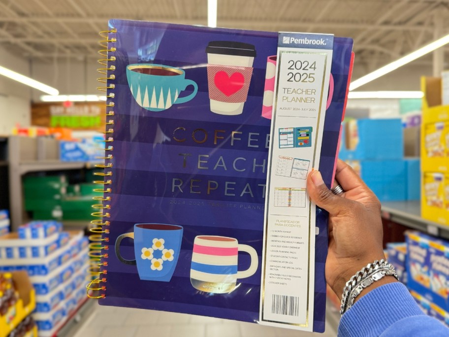 hand holding a Teacher Planner with Coffee Cups on the cover