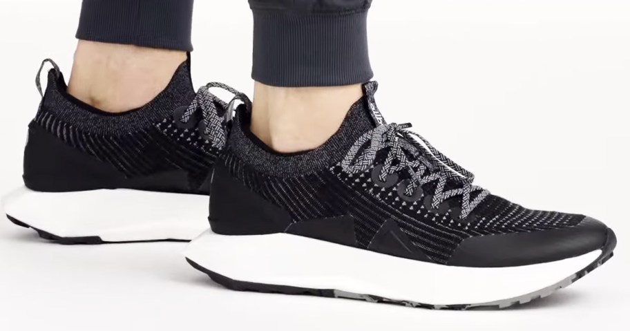 man wearing a pair of black allbirds running shoes