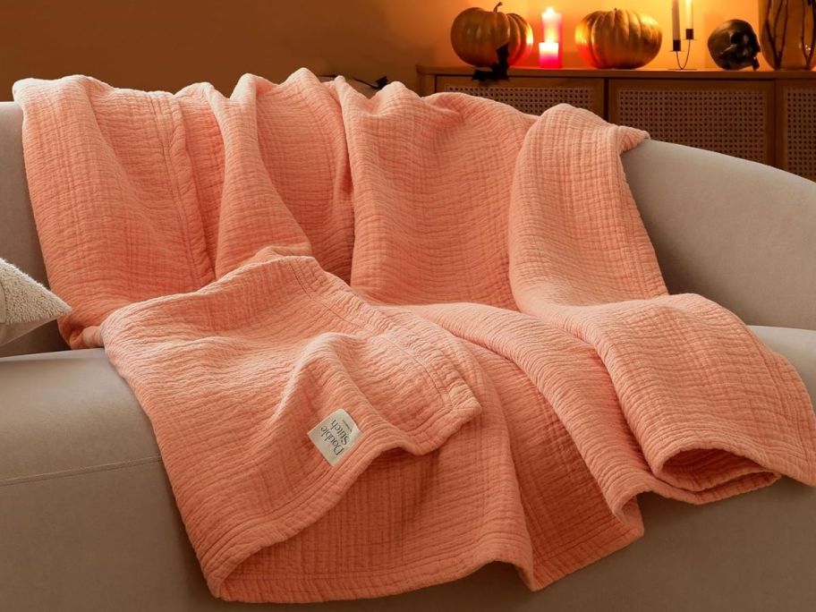 A linen Double Stitch by Bedsure blanket draped over a couch