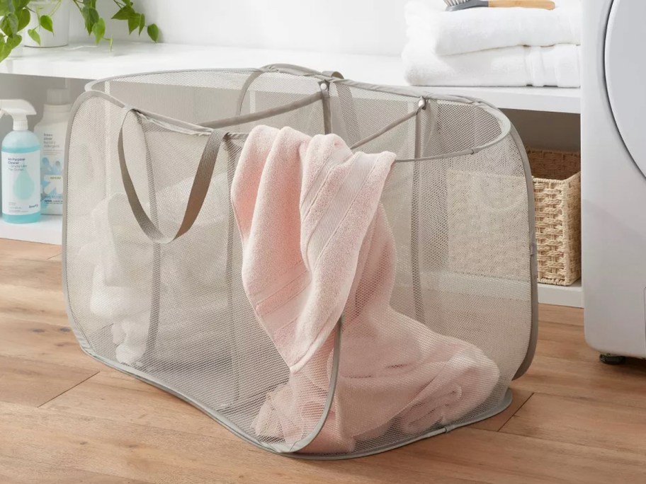 gray mesh hamper with towels