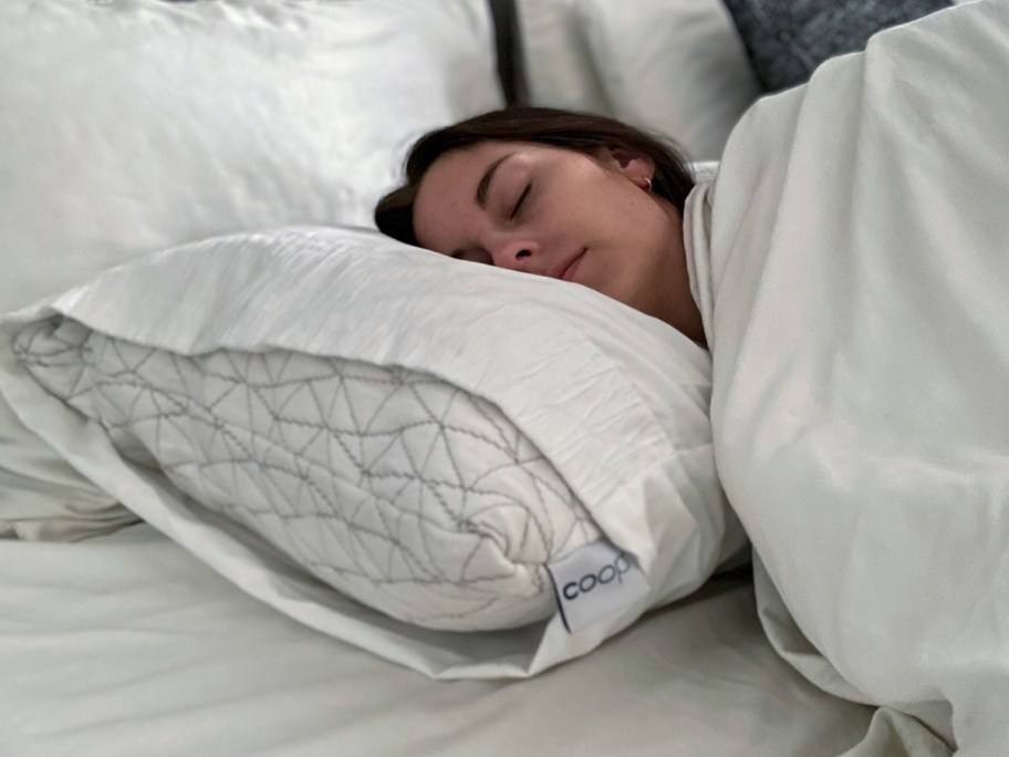 woman laying on a white memory foam pillow in a pillowcase