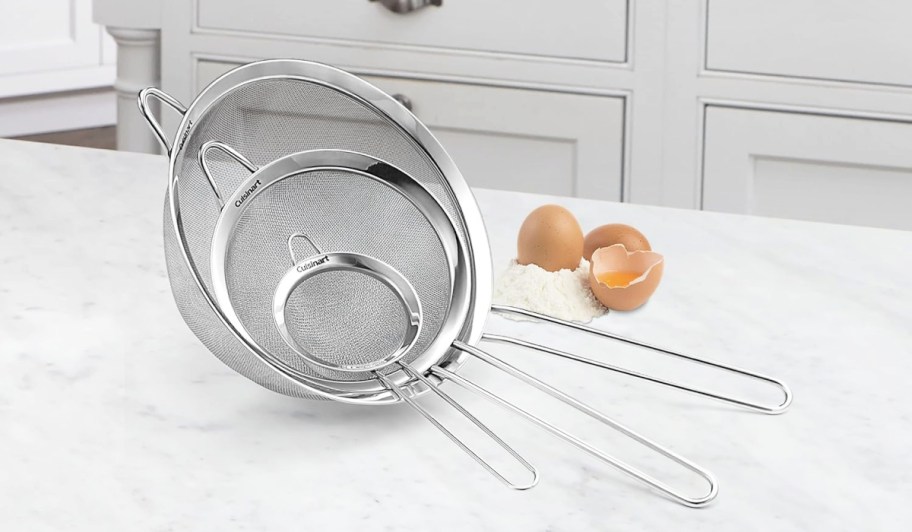 three mesh cuisinart strainers stacked on a counter