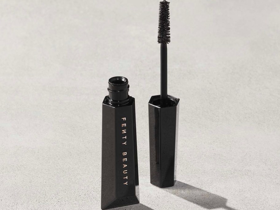 fenty beauty mascara with wand sitting next to it 