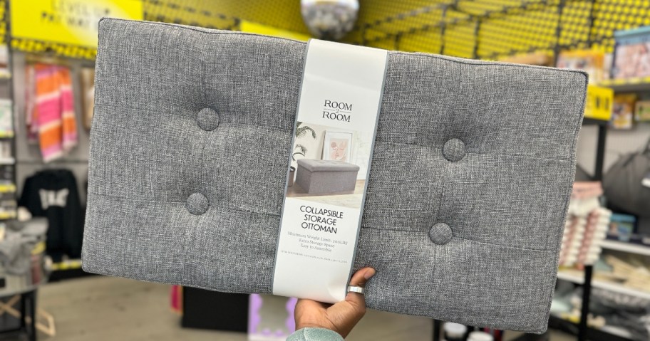 hand holding a grey collapsible storage ottoman at Five Below