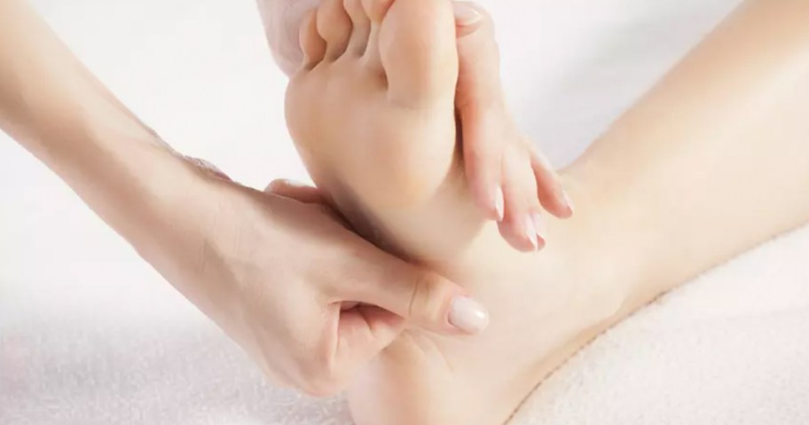 hand massaging foot 