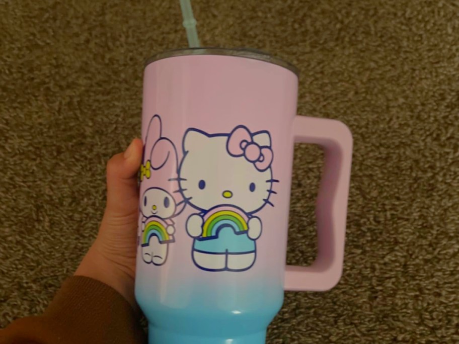 hand holding hello kitty tumbler