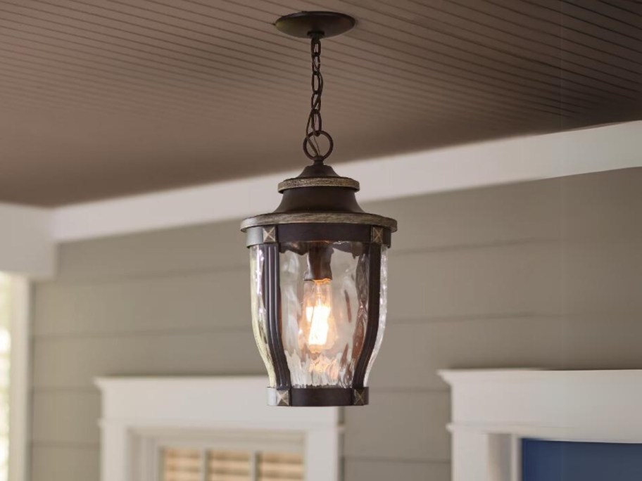 outdoor hanging pendant light with black metal and clear wavy glass