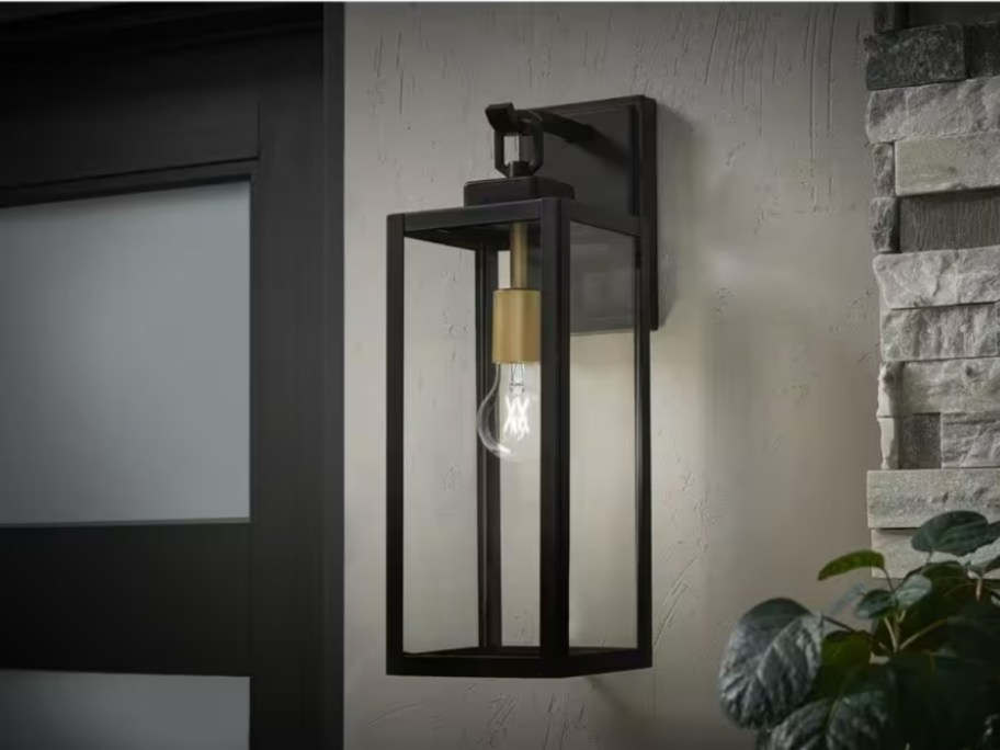 large black metal and glass with gold accents outdoor wall light