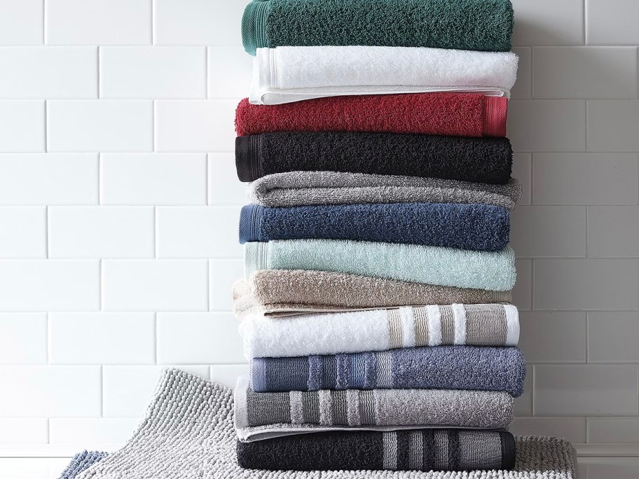 stack of folded towels sitting on rug