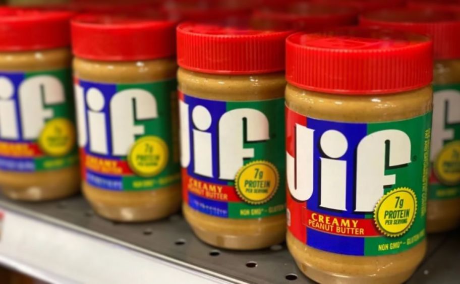 4 jars of Jif peanut butter on a shelf at a store