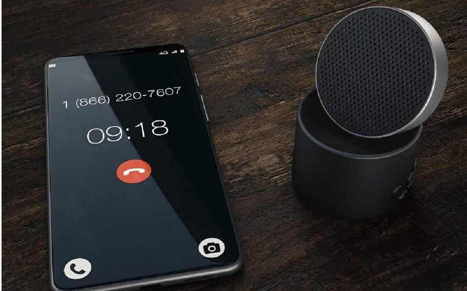 black sound machine next to smartphone