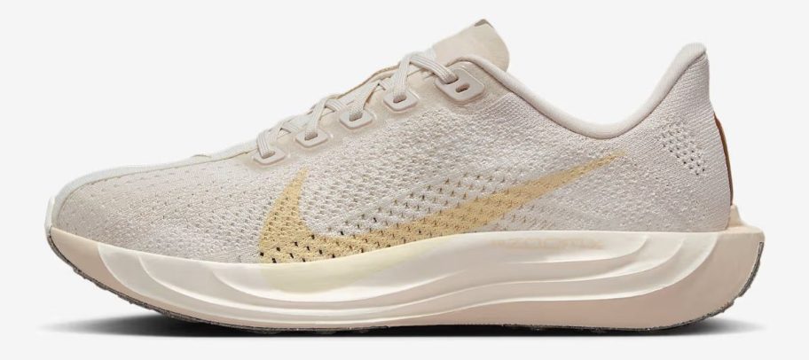 white and orange Nike Pegasus Plus Women's Road Running Shoe stock image